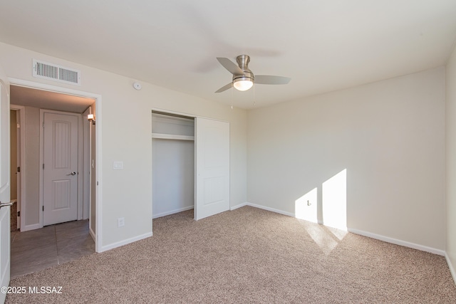 unfurnished bedroom featuring a closet, carpet, visible vents, and baseboards