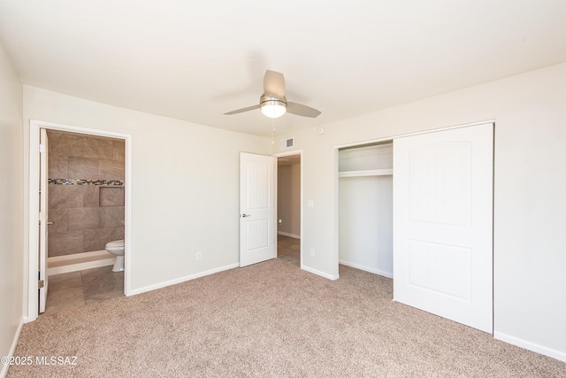 unfurnished bedroom with connected bathroom, light carpet, visible vents, baseboards, and a closet