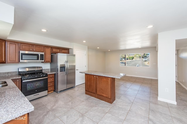 kitchen with brown cabinetry, recessed lighting, stainless steel appliances, and a center island