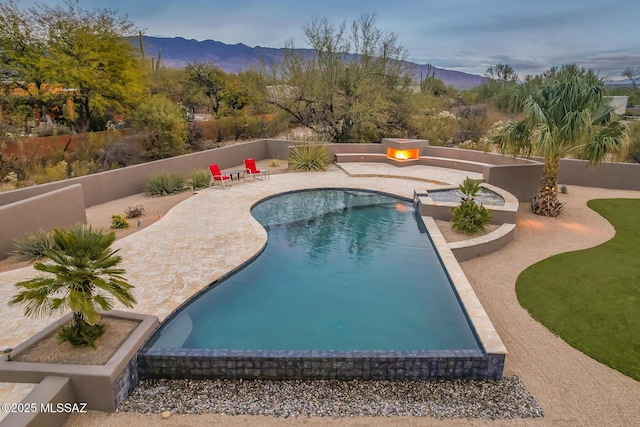 view of pool featuring a mountain view and a patio