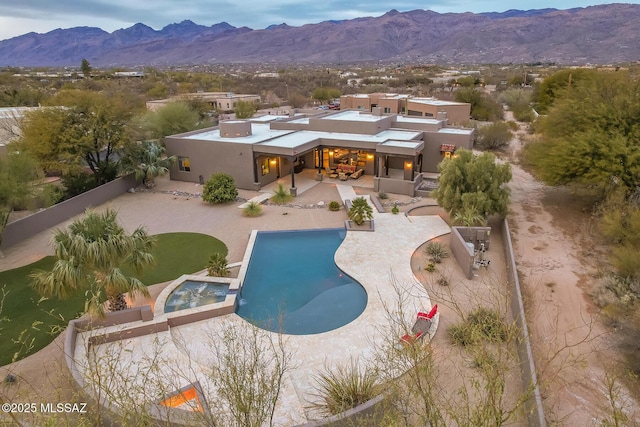 rear view of house featuring a patio area and a mountain view