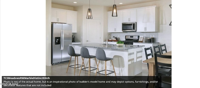 kitchen featuring white cabinetry, appliances with stainless steel finishes, sink, and backsplash