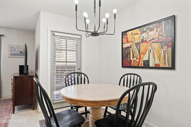 dining space featuring a chandelier, baseboards, and light tile patterned floors