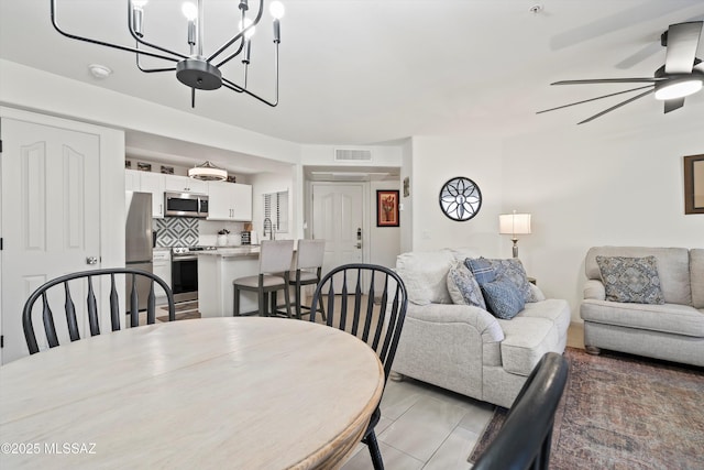 dining room featuring visible vents and a ceiling fan