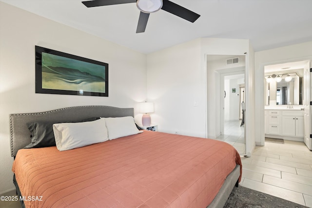 bedroom featuring light tile patterned floors, visible vents, a ceiling fan, connected bathroom, and a sink