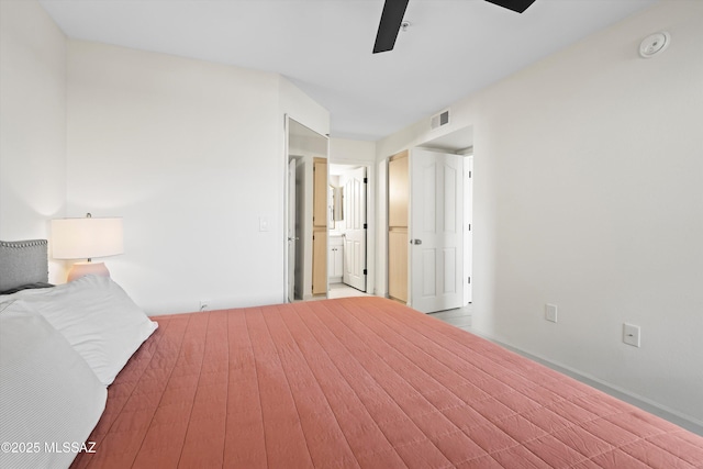 unfurnished bedroom with ceiling fan, connected bathroom, and visible vents