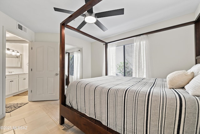 bedroom with ceiling fan, visible vents, a sink, and ensuite bathroom