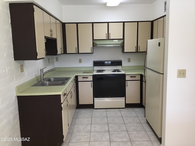 kitchen featuring light countertops, freestanding refrigerator, a sink, range with electric cooktop, and under cabinet range hood