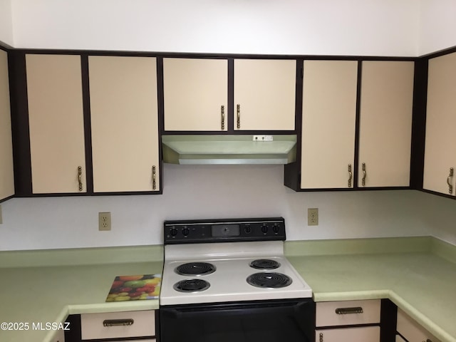 kitchen with under cabinet range hood, light countertops, and range with electric stovetop