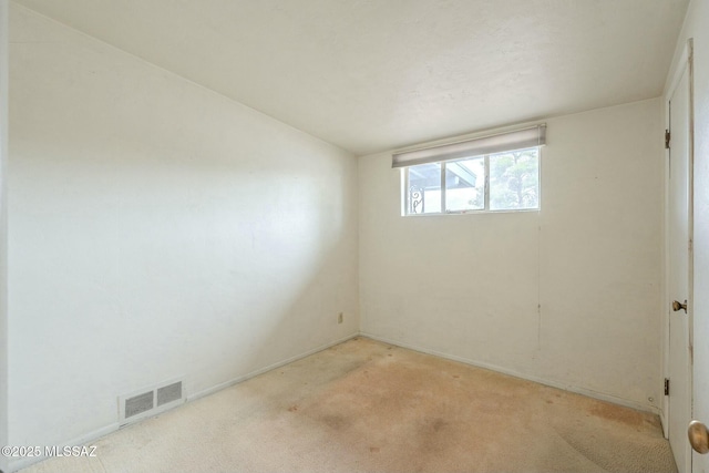 empty room with visible vents and light colored carpet