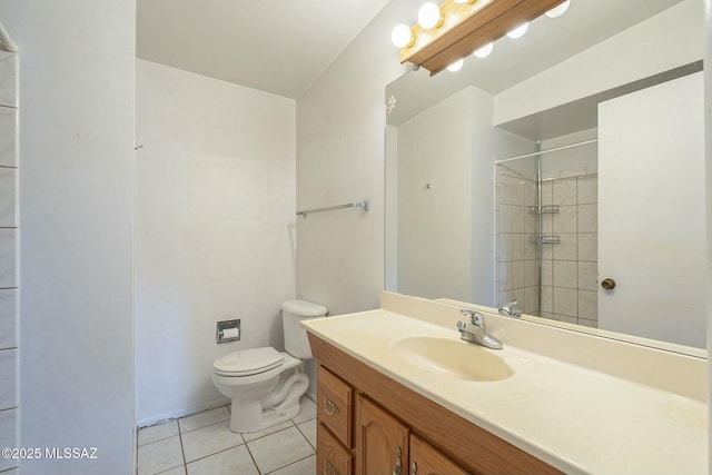 full bathroom with toilet, vanity, a tile shower, and tile patterned floors