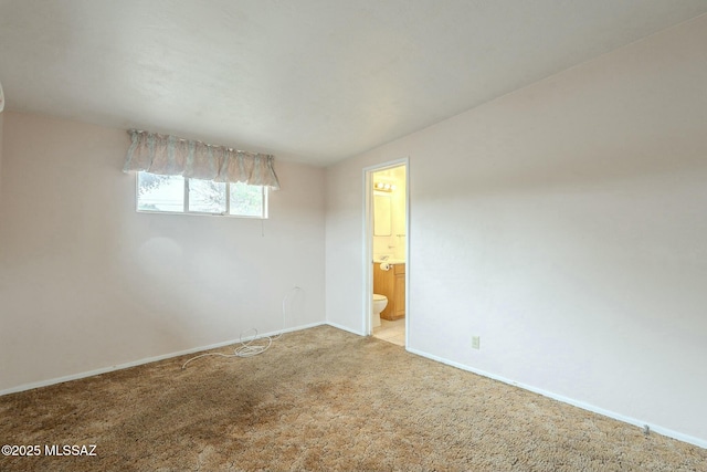 spare room with light carpet and baseboards