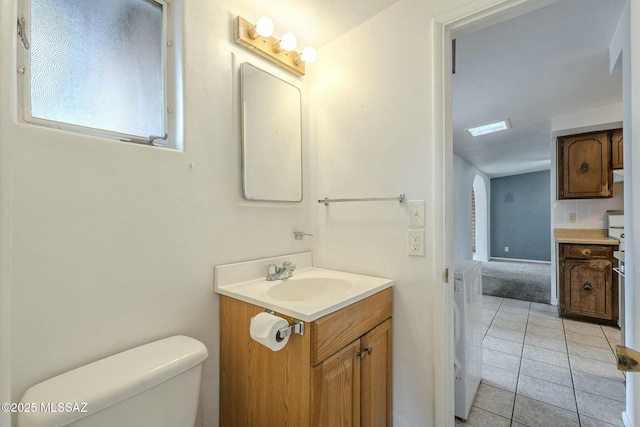 bathroom with vanity, toilet, and tile patterned floors