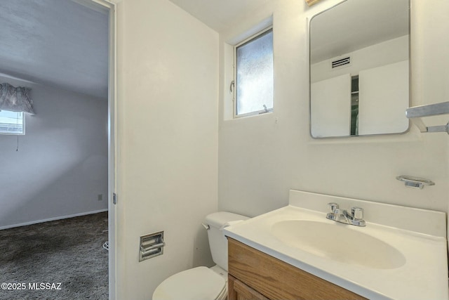 half bathroom with toilet, visible vents, and vanity