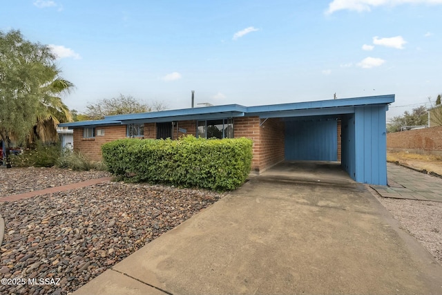 view of front facade featuring an attached carport and brick siding