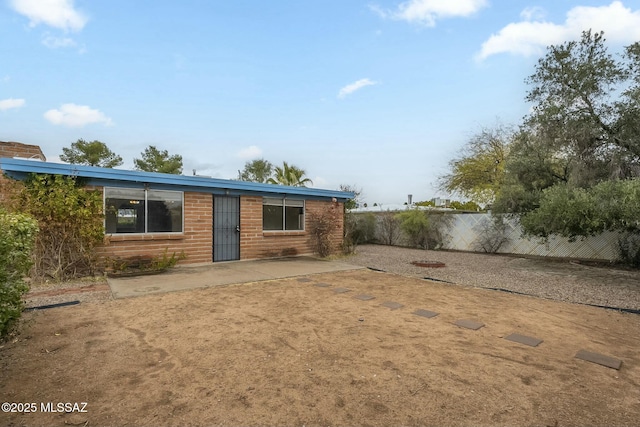 back of house featuring a patio and fence