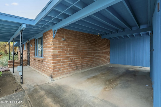 exterior space with brick siding and an attached carport