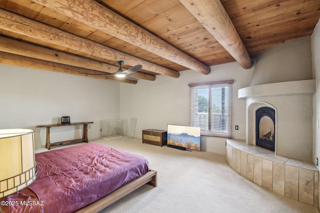 carpeted bedroom featuring beamed ceiling, wooden ceiling, and a fireplace