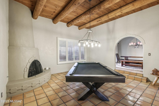 game room with beam ceiling, tile patterned flooring, a fireplace, and wooden ceiling