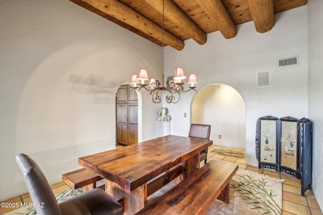 tiled dining room featuring a notable chandelier, beamed ceiling, and wood ceiling