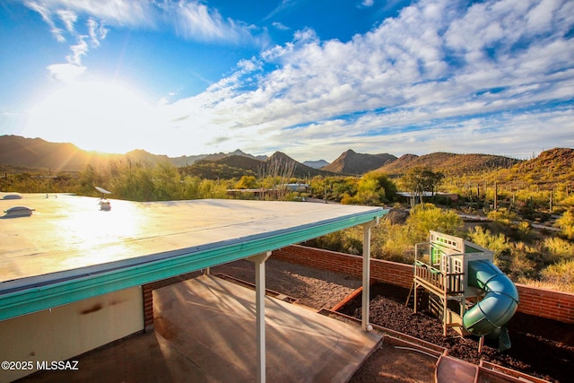 view of pool with a mountain view and playground community