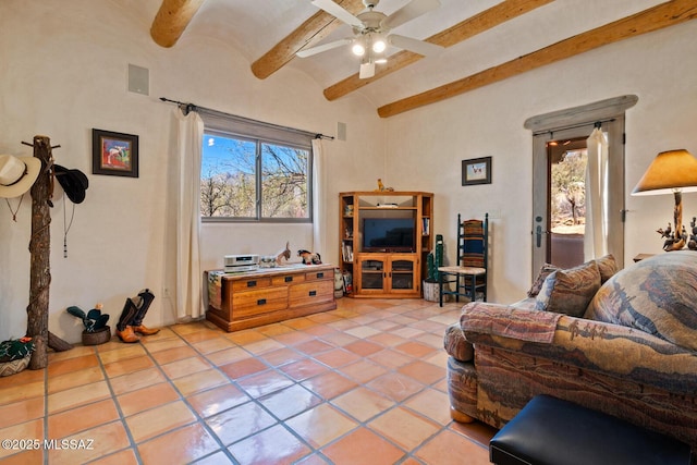 living room featuring tile patterned flooring, beamed ceiling, plenty of natural light, and visible vents