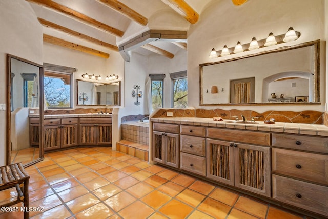 full bathroom with vanity, a bathing tub, tile patterned flooring, a towering ceiling, and beamed ceiling