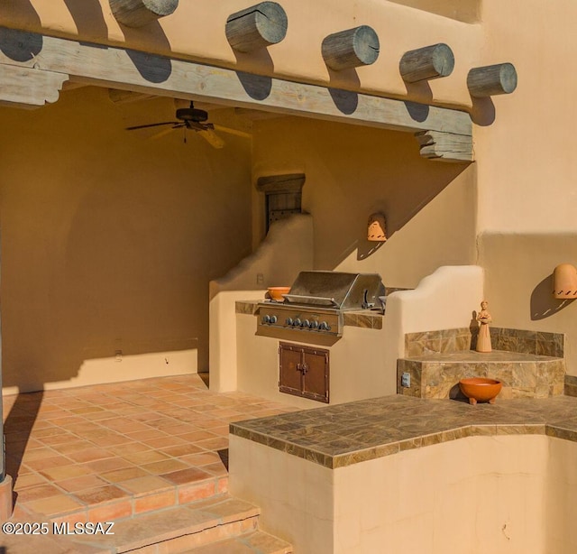 view of patio / terrace featuring area for grilling and ceiling fan