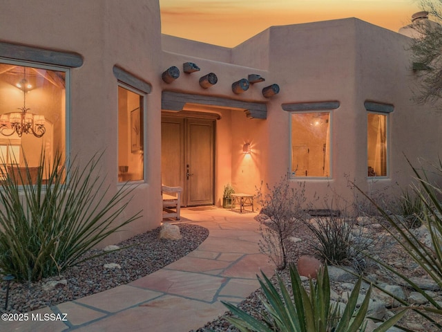 property entrance with stucco siding