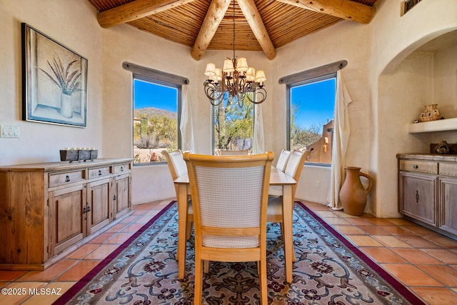 dining space featuring light tile patterned flooring, a notable chandelier, wooden ceiling, and beam ceiling