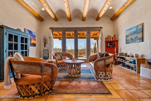 sitting room with tile patterned flooring, beam ceiling, and french doors