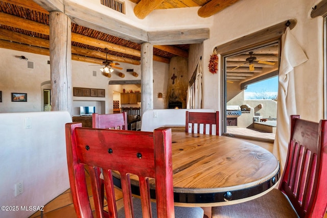 dining room with visible vents, beam ceiling, arched walkways, and a ceiling fan