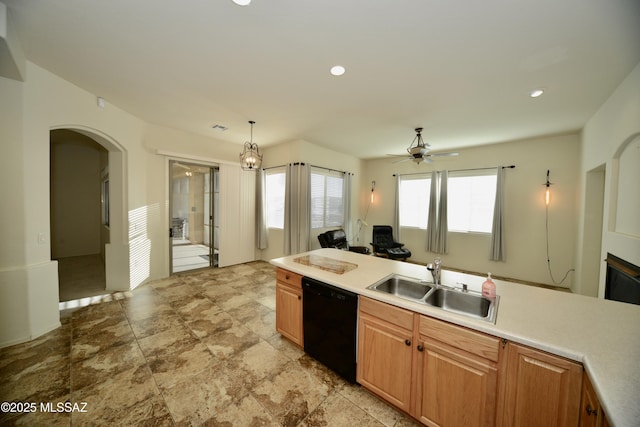 kitchen with arched walkways, recessed lighting, light countertops, a sink, and dishwasher