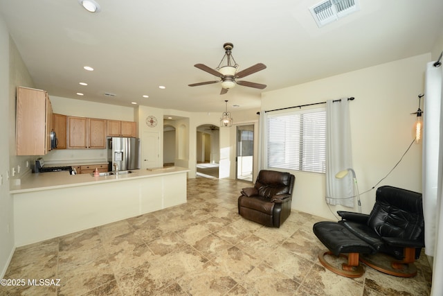 living area featuring arched walkways, visible vents, ceiling fan, and recessed lighting