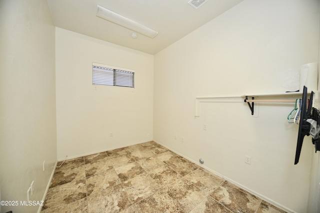 unfurnished room featuring baseboards and visible vents