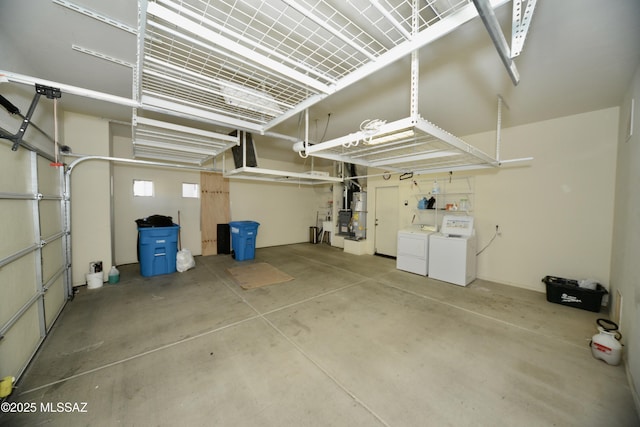 garage with secured water heater and washing machine and clothes dryer