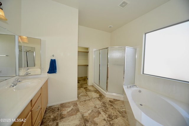 full bath with a garden tub, visible vents, a spacious closet, a shower stall, and vanity