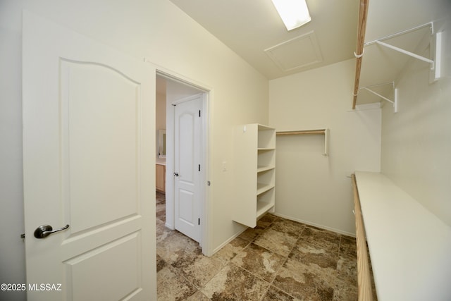 walk in closet featuring attic access