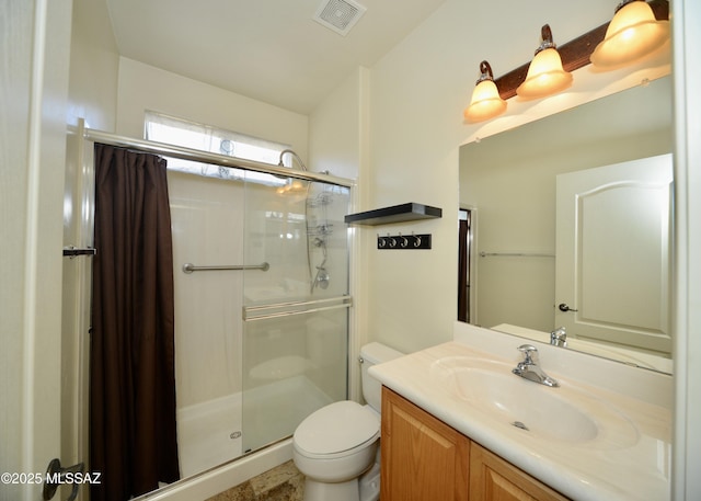 full bathroom with toilet, a stall shower, vanity, and visible vents