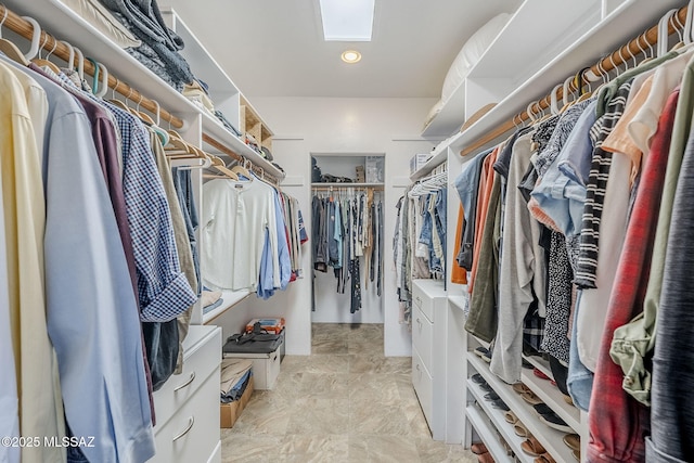 spacious closet with a skylight