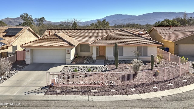 ranch-style home featuring a garage and a mountain view