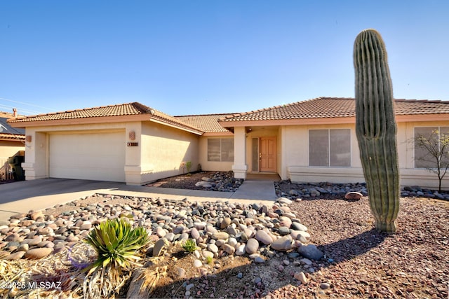 1660 N Fox Run Pl, Tucson, AZ 85715 - view of front facade featuring a garage, driveway, stucco siding, and a tiled roof
