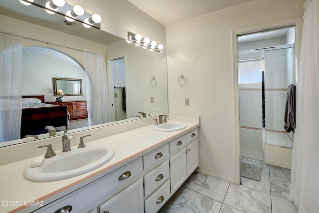 1660 N Fox Run Pl, Tucson, AZ 85715 - ensuite bathroom with a sink, double vanity, marble finish floor, and a stall shower