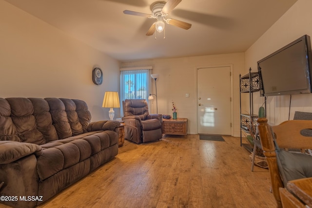 living room featuring ceiling fan and light hardwood / wood-style floors