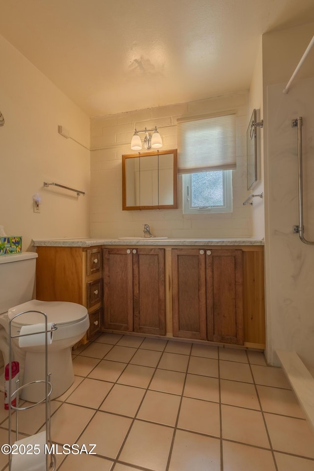 bathroom featuring vanity, tile patterned floors, and toilet