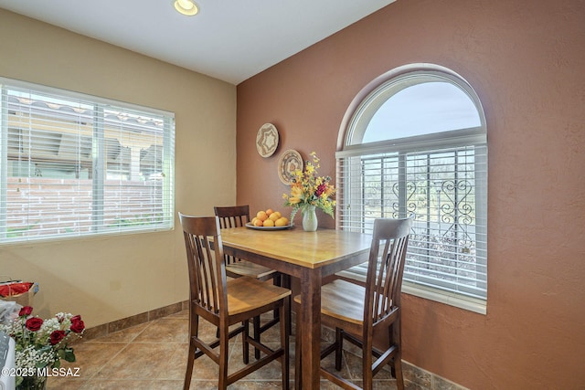 dining room featuring a healthy amount of sunlight and light tile patterned floors