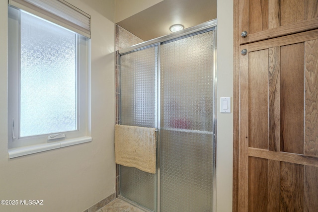 bathroom with a shower with shower door