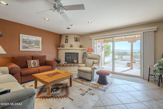 tiled living room with a mountain view and a fireplace