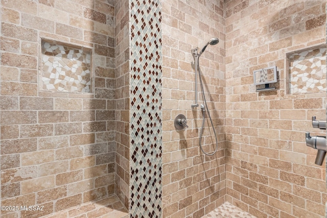 bathroom with tiled shower