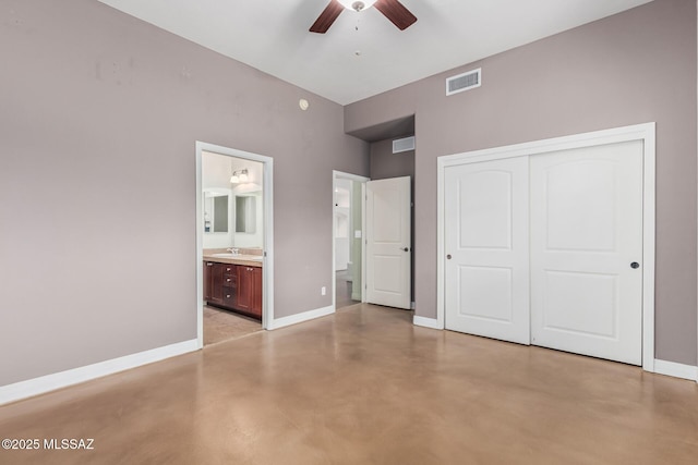 unfurnished bedroom featuring concrete floors, a sink, visible vents, baseboards, and a closet